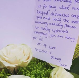 White roses and a handwritten thank-you card from a bride and groom, 2020